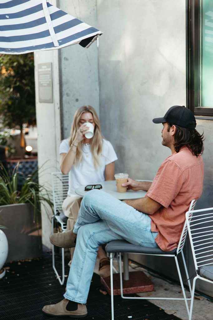 Two friends drinking coffee together