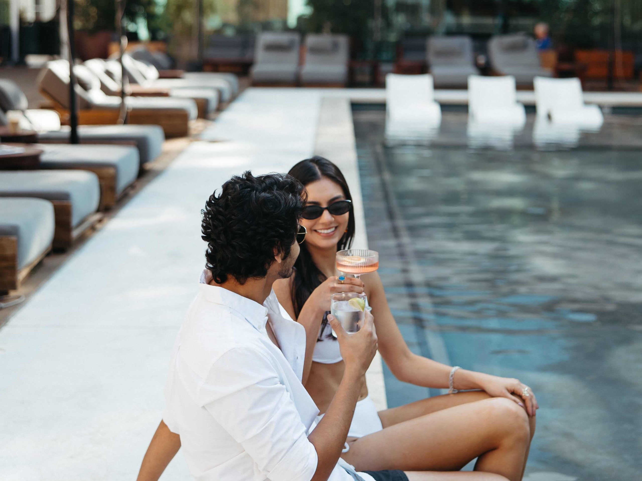 Two people chatting at a pool