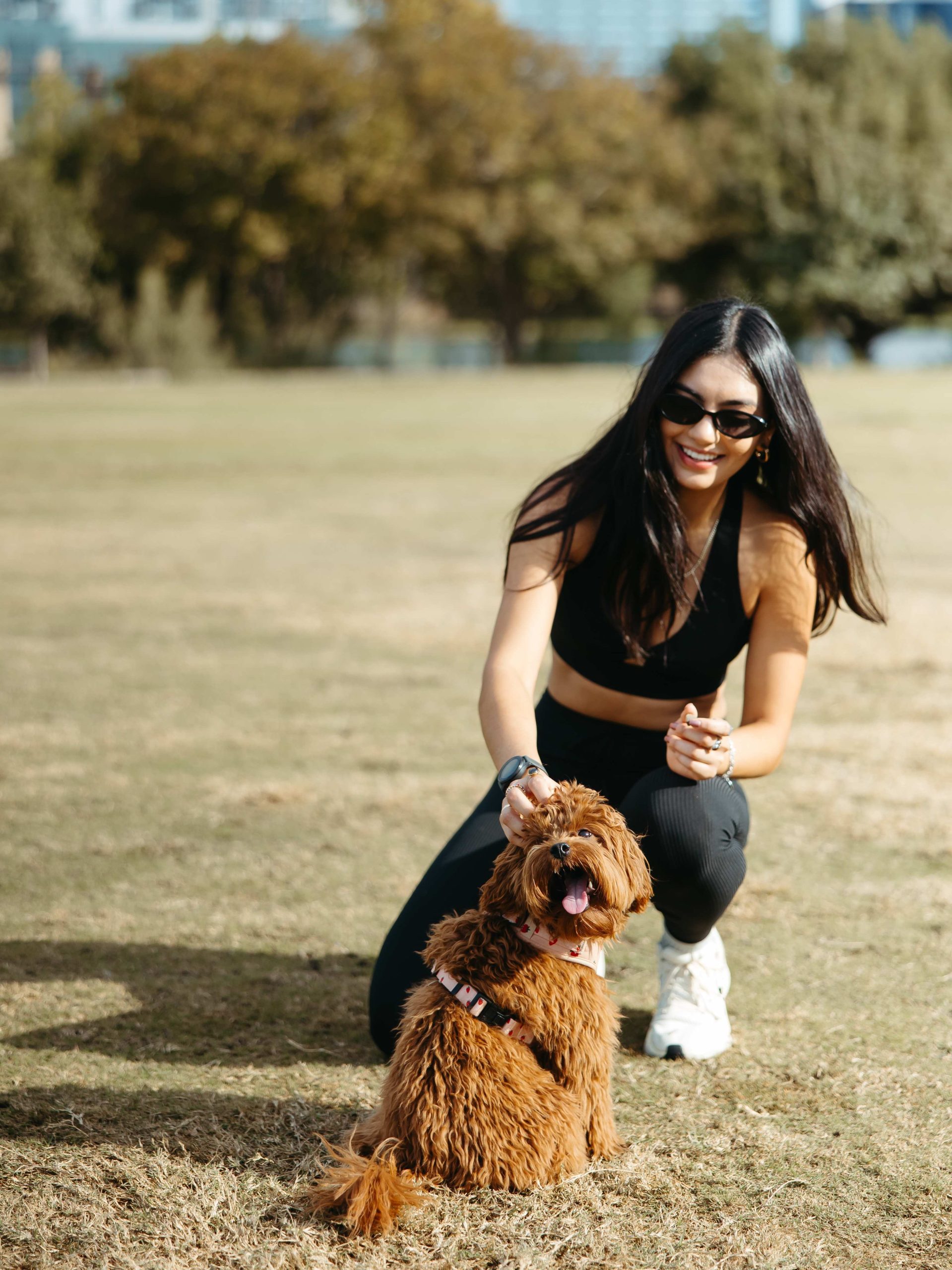 Woman taking a photo with her dog at Zilker Park