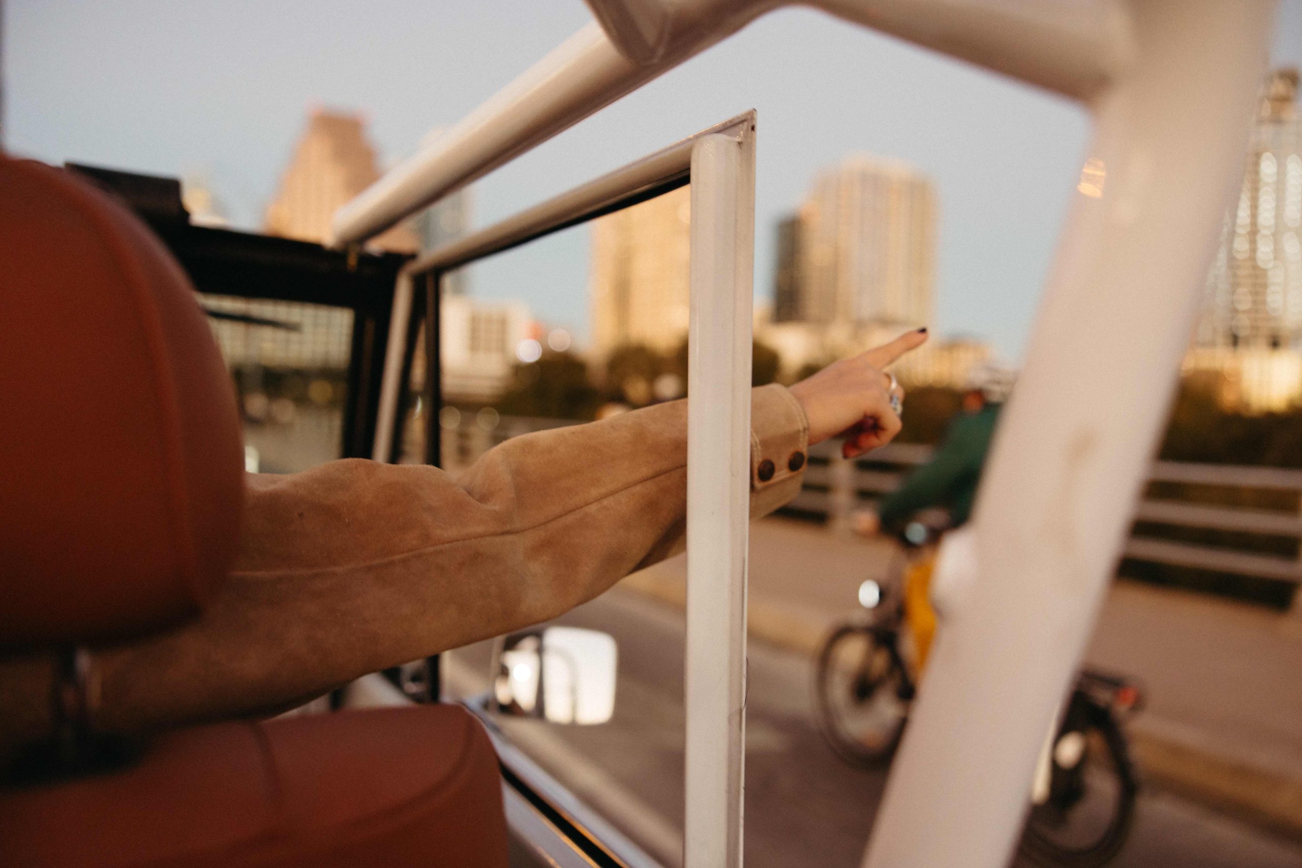 Girl with her hand hanging out of a car window
