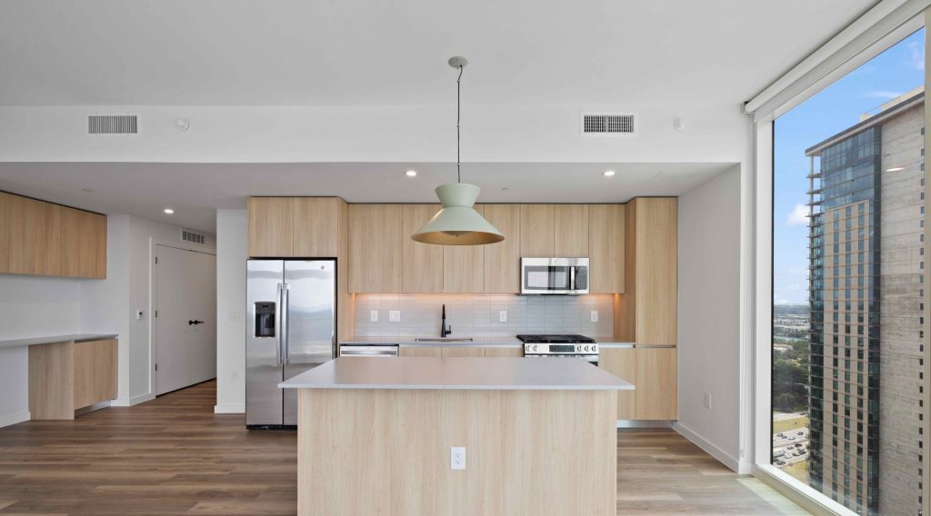 Living and kitchen space at Paseo, Rainey Street apartments in Austin, TX.