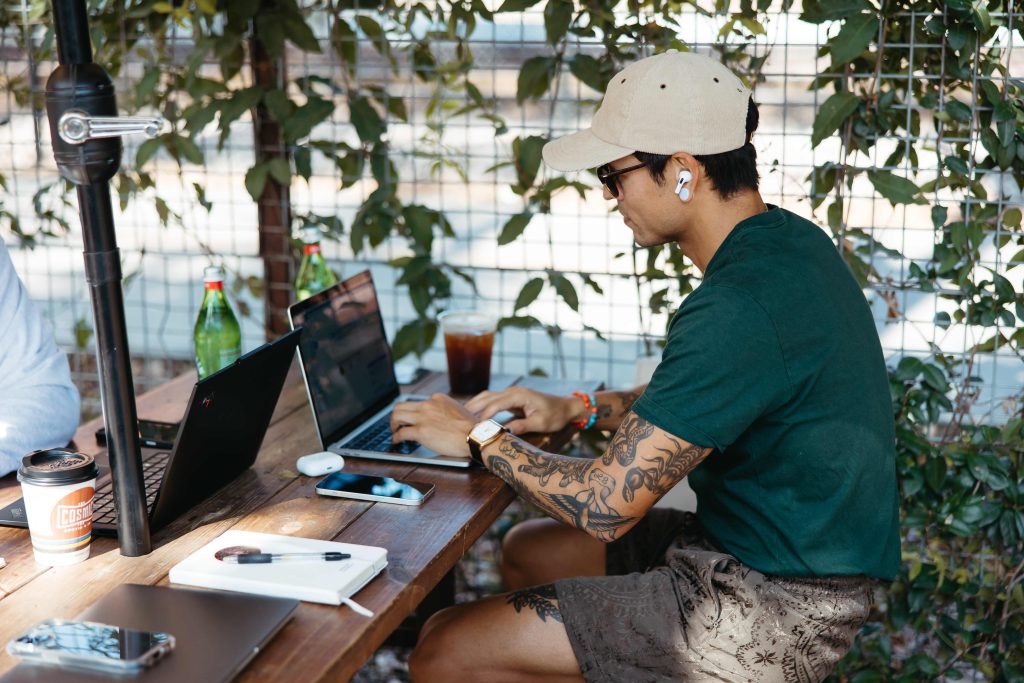 Man sitting at a table doing work on his computer