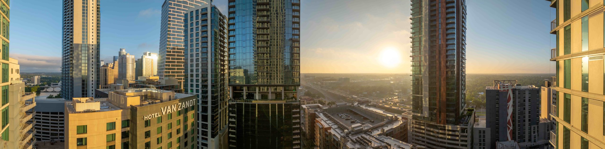 Northeast-facing panoramic view from the 42nd floor, capturing downtown Austin and the sunrise over East Austin.