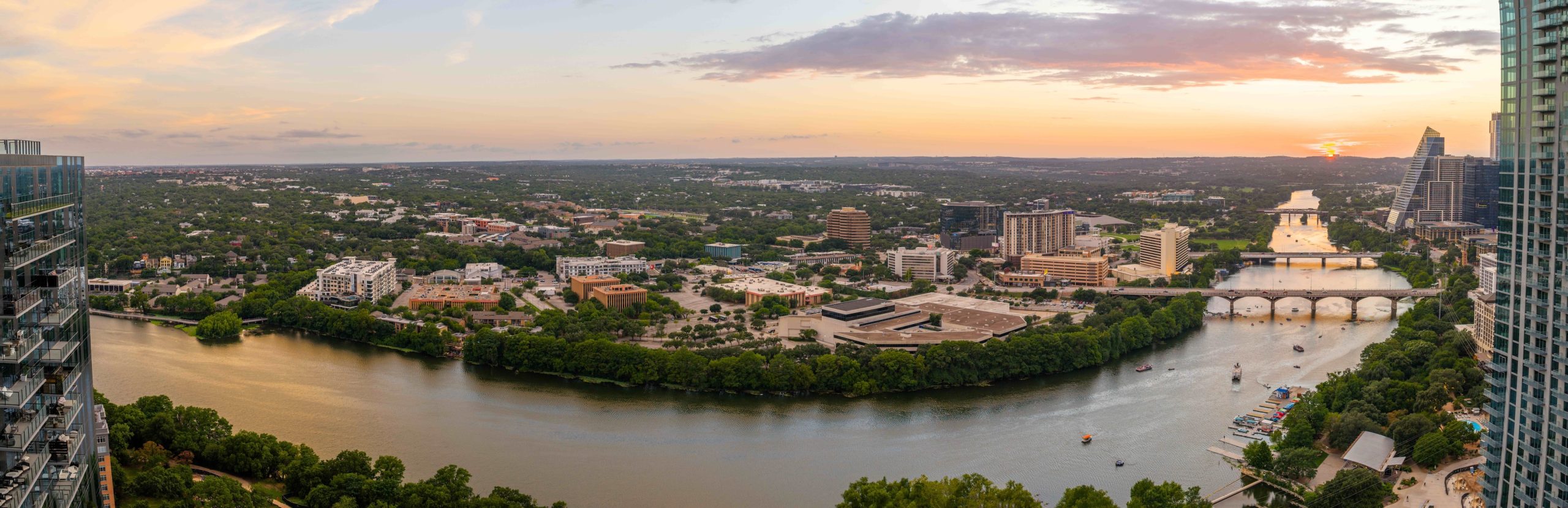 Panoramic west-facing view from the 42nd floor at sunset, overlooking Lady Bird Lake