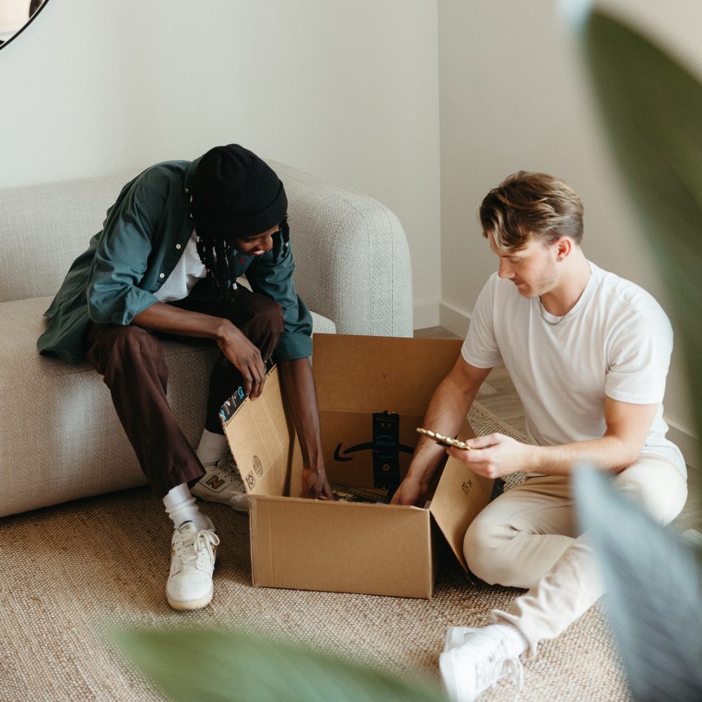 Two Paseo residents unpacking a moving box