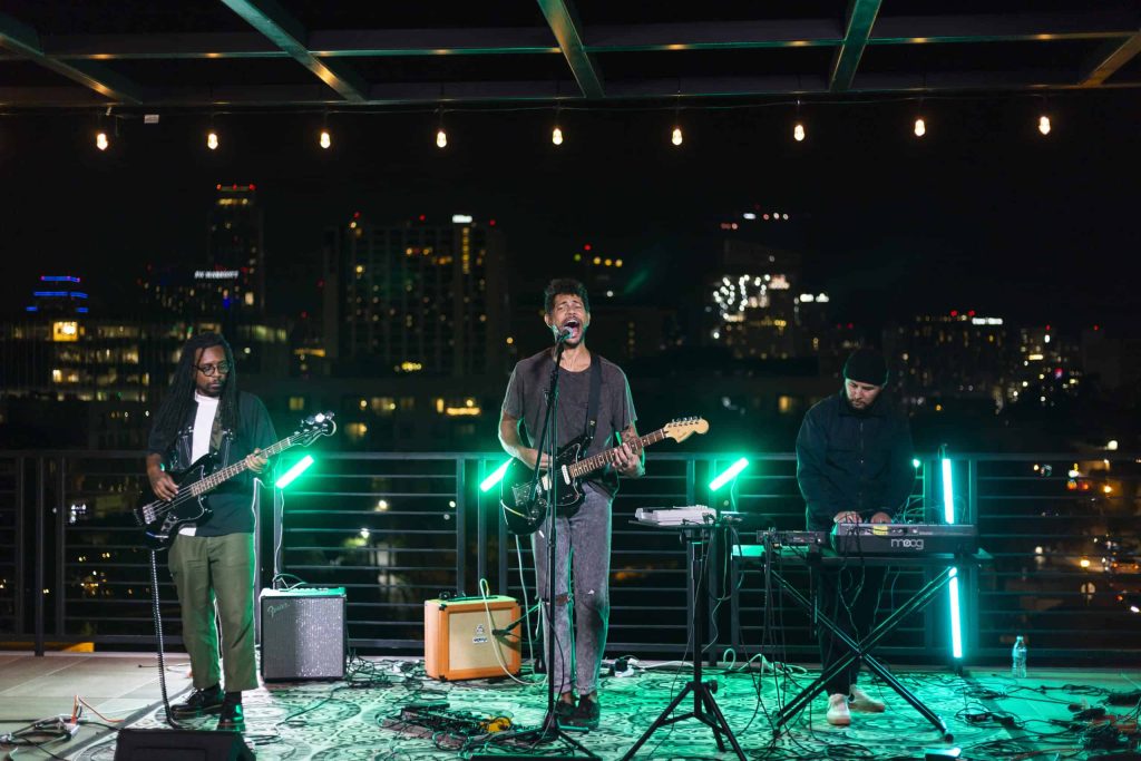 Nighttime rooftop party at IYKYK above Austin Garden & Studio, commonly known as one of the best live music venues downtown Austin, Texas. 
