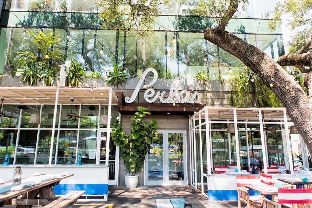 Bustling outdoor patio at Perla's, a restaurant commonly known as one of the best brunch spots in Downtown Austin, Texas.
