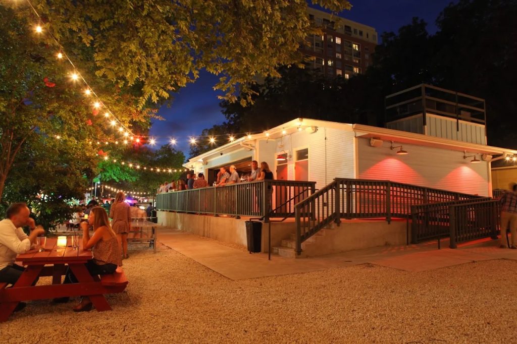 Crowded outdoor space at Half Step, a popular Austin cocktail bar on Rainey Street.