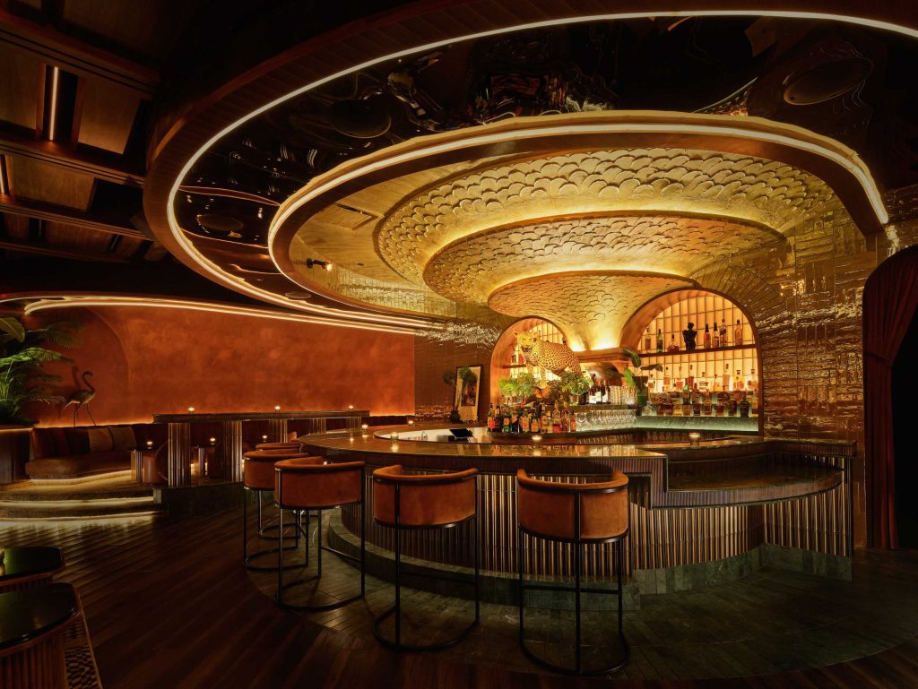 Plush seating and gold-lit interior at Powder Room, a luxurious cocktail bar experience in downtown Austin.