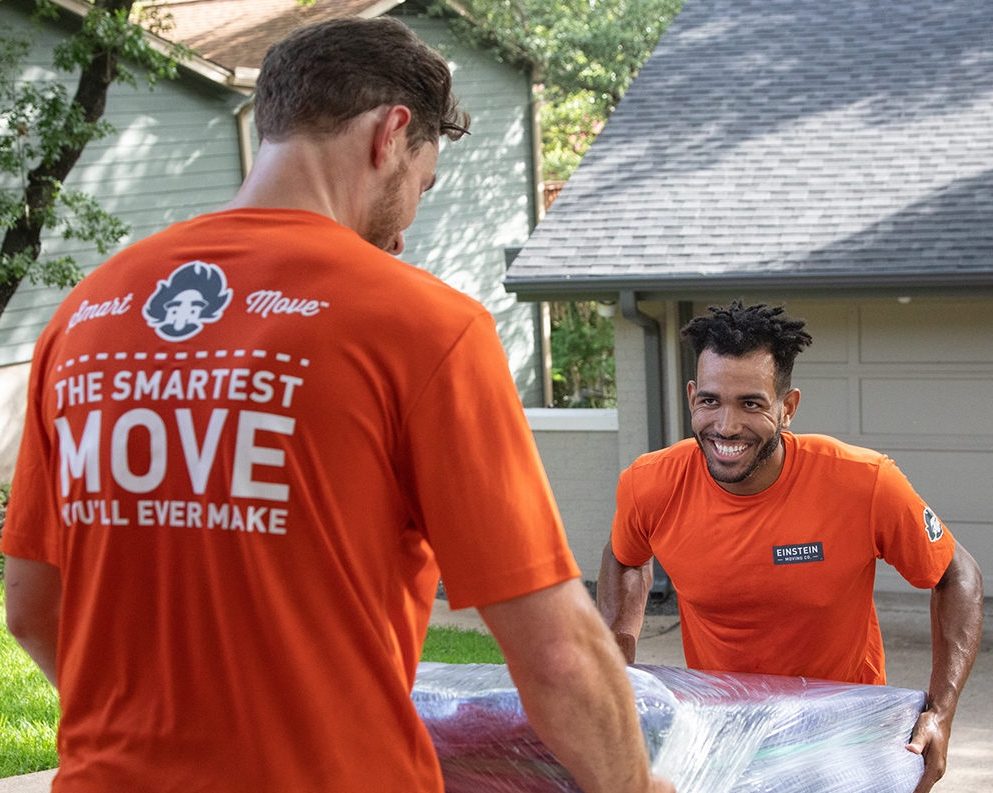 Einstein Moving Co., one of the best Austin moving companies, employees helping unload furniture during a residential move.