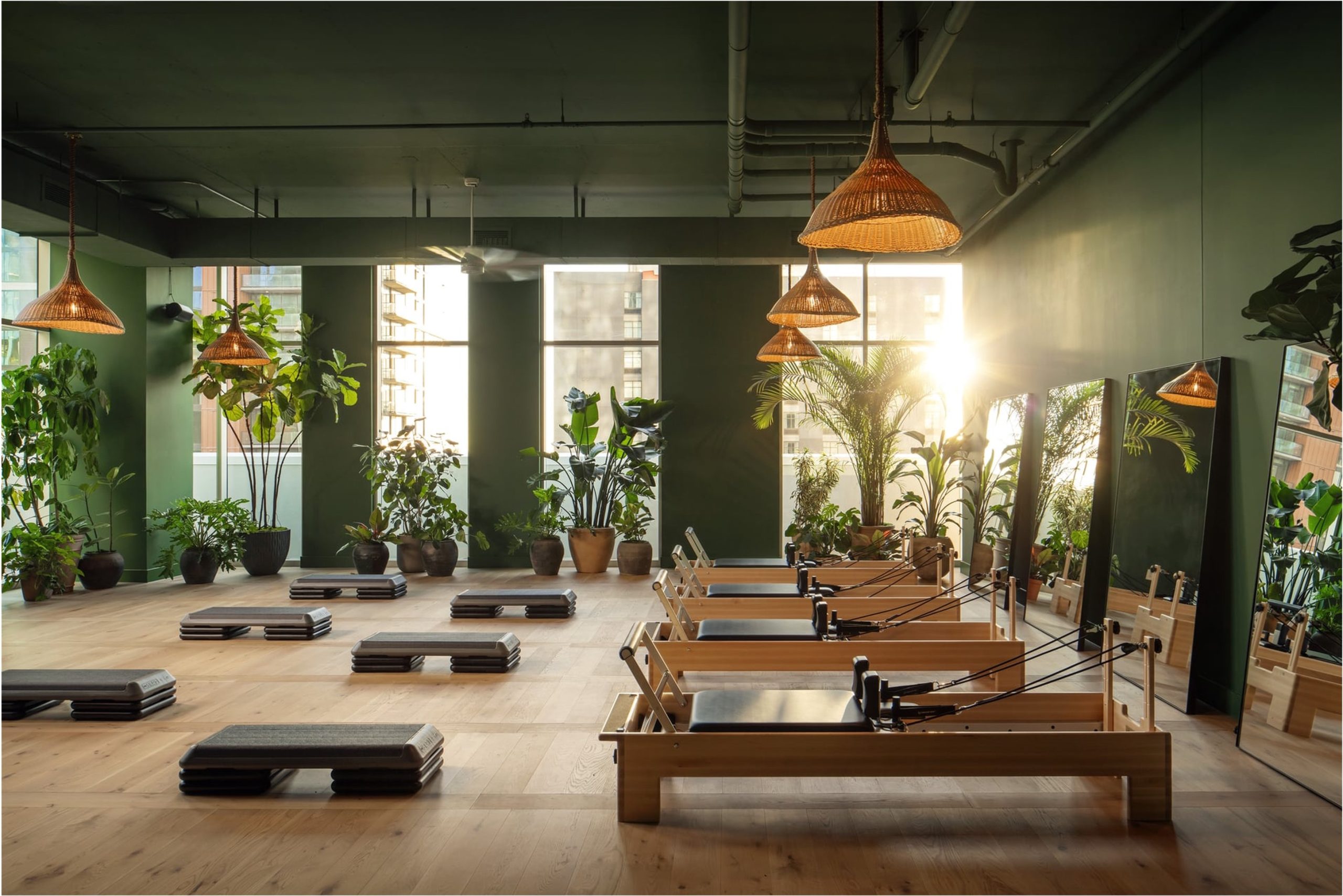 Warm-lit yoga room overlooking Lady Bird Lake at Paseo In Downtown Austin.
